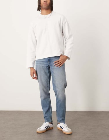 ASOS DESIGN tapered jeans in light wash blue