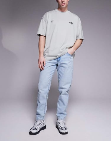 ASOS DESIGN tapered fit jeans in light wash blue