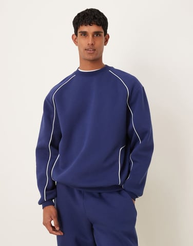 ASOS DESIGN relaxed fit sweatshirt with piping in blue