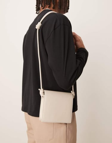 ASOS DESIGN faux leather cross body bag with strap detail in ecru