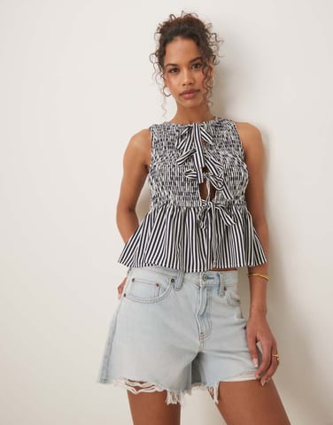 Glamorous shirred top with peplum and front bows in navy white stripe