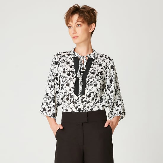 Tulip sleeves blouse with monochrome floral print and contrasting neckline