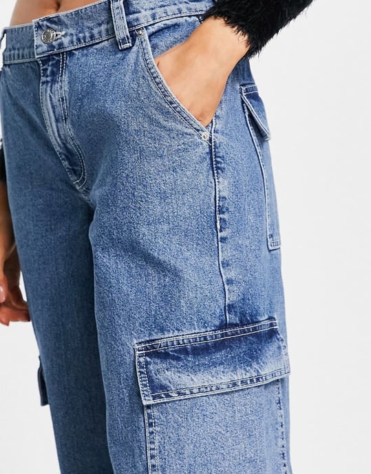 ASOS DESIGN cotton blend low rise 'cargo' jean in mid wash blue