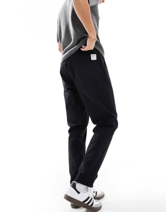 ASOS DESIGN tapered pull on trousers in black with patch - Image 1