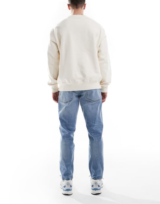 ASOS DESIGN stretch tapered jeans in light wash - Image 2
