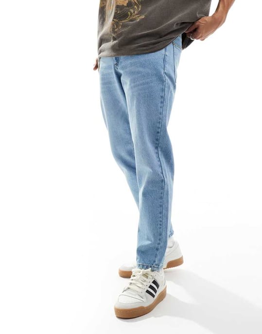 ASOS DESIGN tapered fit jeans in light wash blue - Image 4