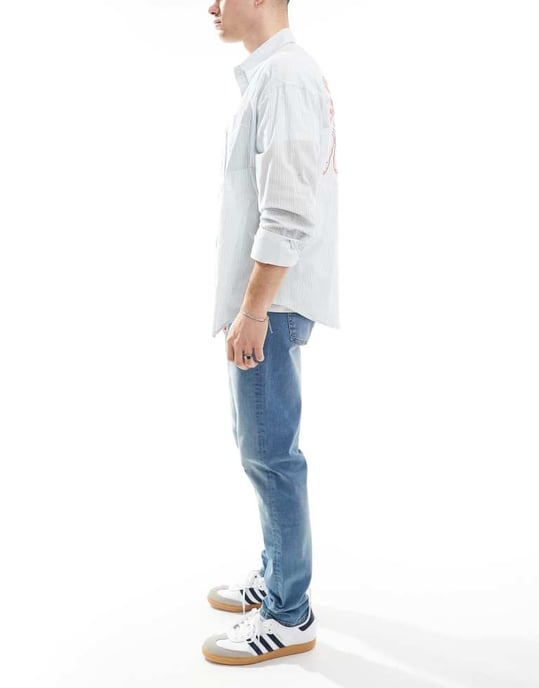 ASOS DESIGN skinny jeans med gul nyans i mellanblå tvätt - Image 3