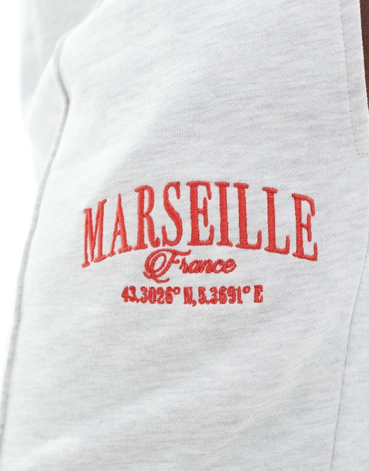 ASOS DESIGN Curve straight leg jogger with Marseille embroidered graphic in ice marl - Image 3