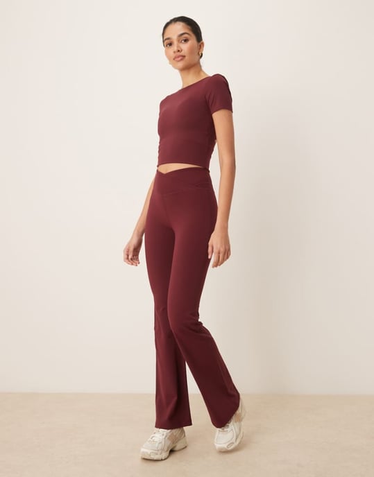 TALA DayFlex wrap high waisted flared yoga pant in burgundy - Image 1