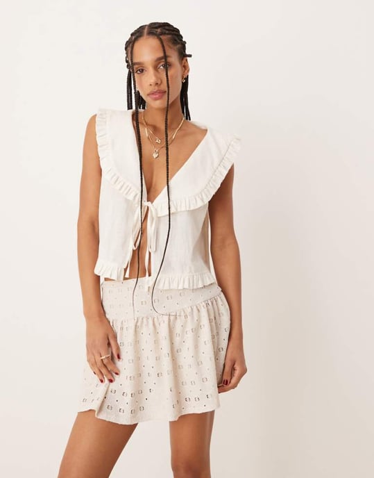 ASOS DESIGN broderie mid rise mini skort in natural - Image 1