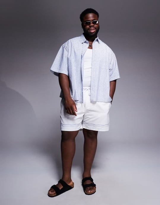 ASOS DESIGN swim shorts in mid length in stone with border print - Image 2