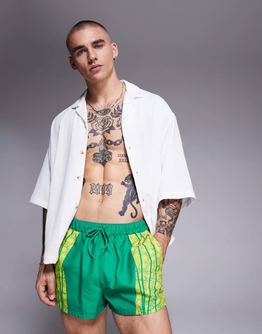 ASOS DESIGN swim shorts in super short length with placement animal print in green - Image 1