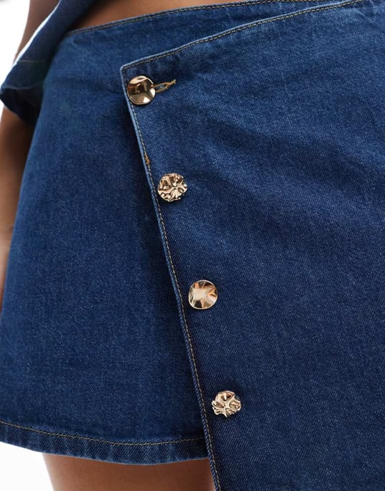 ASOS DESIGN asymmetrisk wrap-front denim microkjol med guldknappar i mid blue - Image 4
