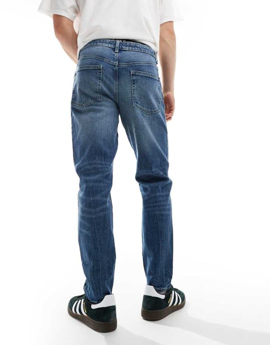 ASOS DESIGN stretch tapered jeans in light wash blue - Image 2