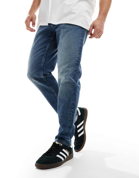ASOS DESIGN stretch tapered jeans in light wash blue - Image 4