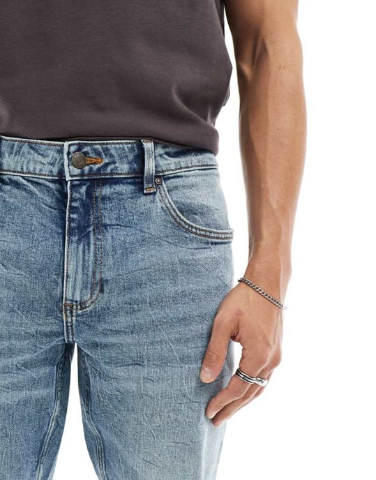 ASOS DESIGN stretch tapered jeans in mid wash blue - Image 4