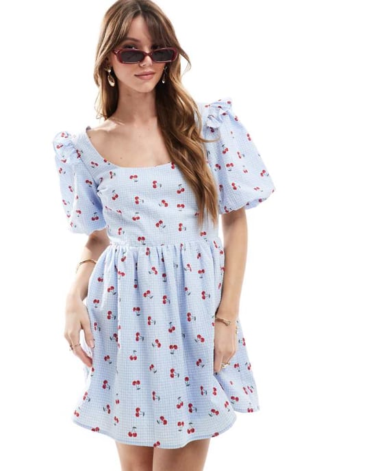 The Frolic exclusive seersucker ruffle puff sleeve shirred babydoll mini dress in blue check and cherry print - Image 1