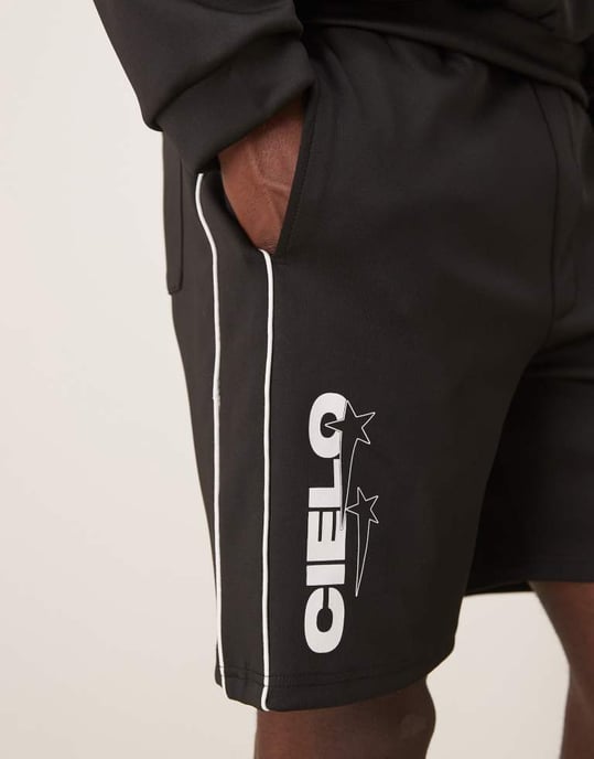 ASOS DESIGN oversized scuba-liknande tygshorts med tryck i svart co ord - Image 3