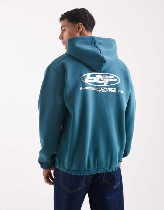 ASOS DESIGN hoodie med metallisk sporttryck i tealblå - Image 1