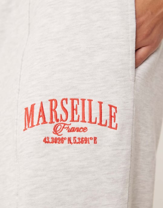 ASOS DESIGN straight leg jogger with Marseille embroidered graphic in ice marl - Image 2
