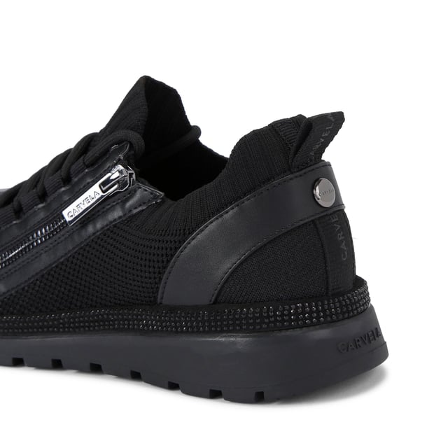 This Carvela Pace Zip Knit trainer features a black fabric upper with slight glimmer. The front laces are tubular with a gunmetal zip on the eye stay. There is a black crystal panel around the midsole.