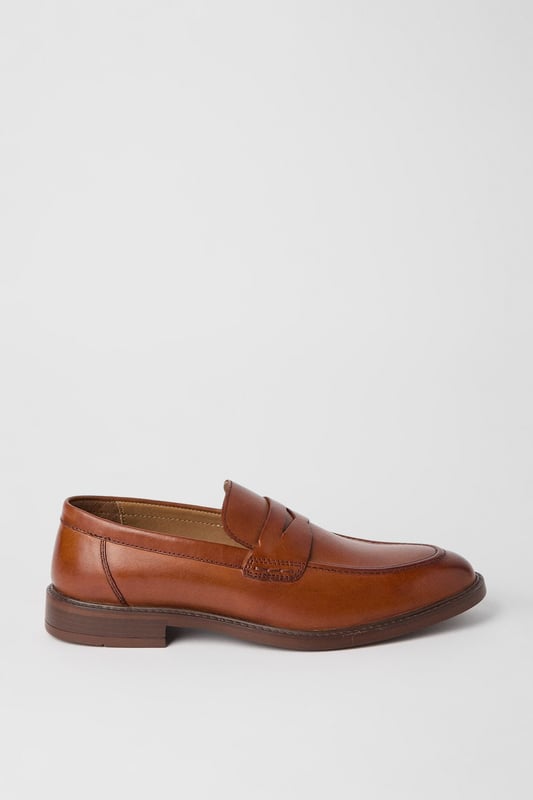Classic penny loafer design with a modern twist
        Smooth leather upper for a polished appearance
        Slip-on style for easy wear
        Sturdy sole with a slight heel for comfort
        Versatile tan colour suitable for various outfits
    
    Step into sophistication with these smart penny loafers from Maine. The timeless design is given a contemporary update, perfect for the modern gentleman who appreciates classic style. These versatile shoes effortlessly bridge the gap between smart and casual, making them an ideal choice for a range of occasions. Pair them with tailored trousers and a crisp shirt for a refined office look, or dress them down with chinos and a polo shirt for smart-casual events. The slip-on style ensures convenience, while the durable sole provides all-day comfort. Whether you're attending a business meeting or enjoying a weekend brunch, these loafers will add a touch of elegance to your ensemble. Their ability to complement both formal and relaxed attire makes them a must-have addition to any discerning wardrobe.
