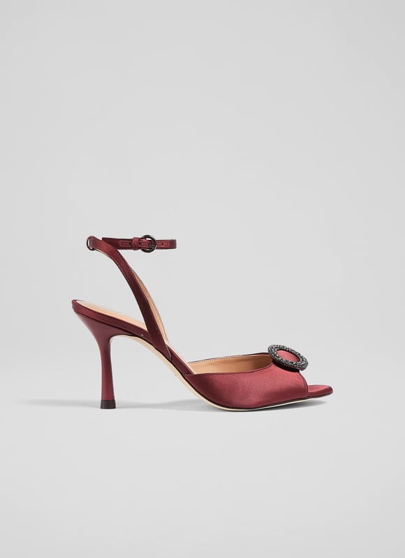 LK Bennett Belle Formal Sandals, Burgundy An elegant and timeless take on a party sandal, our Belle sandals have a glamorous, vintage feel. Crafted from lustrous burgundy satin, they're a peeptoe style with a sparkling, oval-shaped crystal buckle embellishment, a delicate ankle strap and a shapely stiletto heel. Wear them with your favourite party dresses or to instantly dress up a pair of tailored trousers.