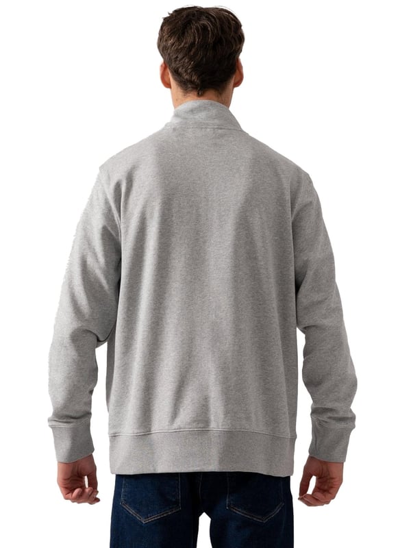 This versatile half-zip sweatshirt combines comfort and style with a premium cotton-polyester blend that's perfect for transitional weather. Featuring a small, intricately embroidered GANT graphic on the chest, it showcases a subtle yet elevated design. The ribbed hem and cuffs create a tailored silhouette. Designed for a regular fit, the half-zip collar adds a touch of sporty elegance, while the durable fabric ensures long-lasting wear.