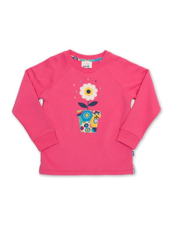 100% organic cotton | Proud to be certified to the Global Organic Textile Standard (GOTS) | Flower appliqué featuring our patchwork planet print | OEKO-TEX Standard 100 (Product class I) appliqué backing | Petal pink | Brush back sweat fabric 3 ply (290-300 gsm) | Coconut button raglan sleeve opening (up to and including size 3 years) | Long sleeved | Round neck | Ribbed neckline and cuffs | Made in Turkey | Machine washable at 40 degrees, or at 30 degrees to be kinder to the planet