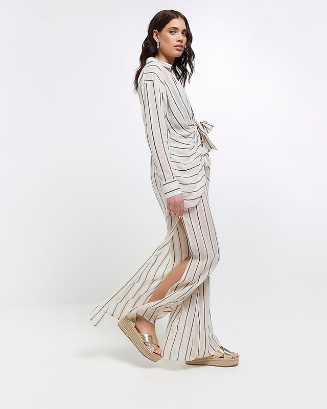 Stripe print, Mid rise, Flared design, Split hem, Elasticated waist, Made with at least 50% sustainable viscose, Our model wears a UK 8 and is 175cm/5'9'' tall