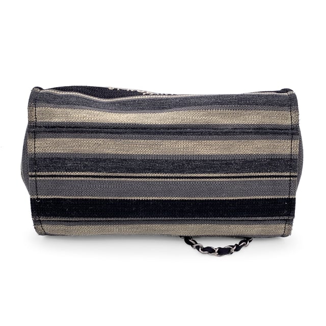 VINTAGE, RRP AS NEW
Beautiful Chanel 'Deauville' tote, crafted in black, grey and beige striped canvas with a white 'Chanel CC31, Rue cambon - Paris' logo. Period/Era: 2018/2019. Double black eather top handles and silver metal and interwoven leather shoulder straps. Magnetic button closure on top. The interior is in beige canvas lining. 2 side zip pockets inside. Leather strap with hook inside. 'CHANEL - made in Italy' tag inside. ity hologram tag inside Condition Rating: B - VERY GOOD CONDITIONCondition Details: Gently used. Some normal wear of use on bottom corners. Some darkness, small stains and normal wear of use on the internal lining. The fabric of the upper border is slightly discolored. Please, check carefully the photos or ask if you have any doubts. Measurements (cm):Depth: 20.3Height: 25.4Length: 43.2Other Details: Dustbag? NoKeys? NoBox? NoMeasurments:  width: 203 mm length: 432 mm height: 254 mm
