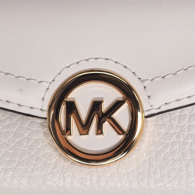 Michael Kors purse in smooth and grained leather.
 In an extra small size, its tri-fold silhouette contains a front and back card slot, room to store your cash, and an exterior snap-close compartment for easy access.
 Throw it in your bag or carry it alone when you only need the essentials.
 Seams seen in tone.
 Gold tone hardware.
 Measures: 9.5 cm (W) x 7 cm (H) x 4 cm (D)
 Composition: 100% Leather
 Care:
Clean with a wet cloth.