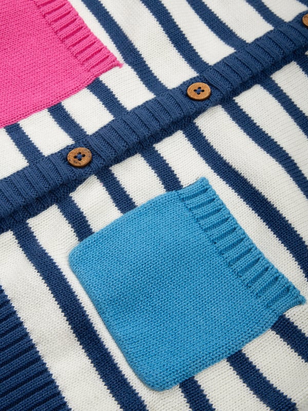 100% organic cotton | Proud to be certified to the Global Organic Textile Standard (GOTS) | Cream and navy blue knitted stripe | Featuring contrast colour sleeves, pockets and neckline | Midweight 7-gauge plain knit | Coconut button fastening | Contrast front pockets | Long sleeved | Round neck | Made in India | Machine washable at 40 degrees, or at 30 degrees to be kinder to the planet