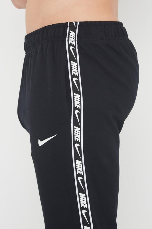 Nike swoosh cuffed top joggers in black