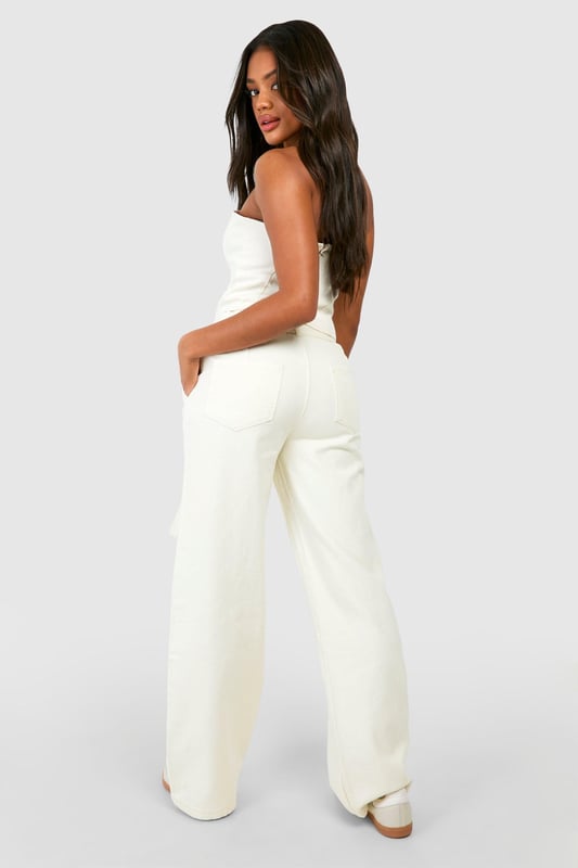 Intricate crochet design for a unique, textured look
        Wide-leg silhouette for a relaxed, on-trend fit
        Strapless bodice with a flattering straight neckline
        Matching belt to cinch the waist and add definition
        Delicate lace trim detailing for added femininity
    
    Make a statement in these eye-catching crochet jeans that blend comfort with style. The wide-leg cut offers a relaxed fit that's perfect for casual outings, while the strapless bodice adds a touch of allure. Style these jeans with a cropped cardigan and trainers for a laid-back daytime look, or dress them up with strappy sandals and statement earrings for evening drinks with friends. The versatile design makes them ideal for summer festivals, beach holidays, or casual weekend brunches. The matching belt allows you to customise the fit, accentuating your waistline. These jeans are a must-have addition to your wardrobe, offering a fresh take on denim that's sure to turn heads wherever you go.