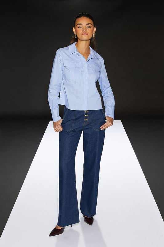 Cropped boxy silhouette for a contemporary edge
        Utility-inspired design with functional chest pockets
        Crisp poplin fabric for a polished look
        Versatile collared neckline
        Part of the exclusive RUNWAY 1.8.1.8 collection
    
    Embrace effortless chic with this Runway 1.8.1.8 Stripe Poplin Cropped Boxy Utility Shirt. The cropped length and boxy fit create a modern silhouette that's perfect for the fashion-forward woman. Style this versatile piece for a range of casual occasions - pair it with high-waisted jeans and trainers for a relaxed weekend look, or tuck it into a midi skirt with ankle boots for a smart-casual ensemble. The utility-inspired design, complete with practical chest pockets, adds a touch of functionality to your wardrobe. Whether you're heading to a family gathering or meeting friends for brunch, this shirt will keep you looking stylish and feeling confident. The crisp poplin fabric ensures a neat appearance throughout the day, making it an ideal choice for those who appreciate both comfort and style in their daywear.