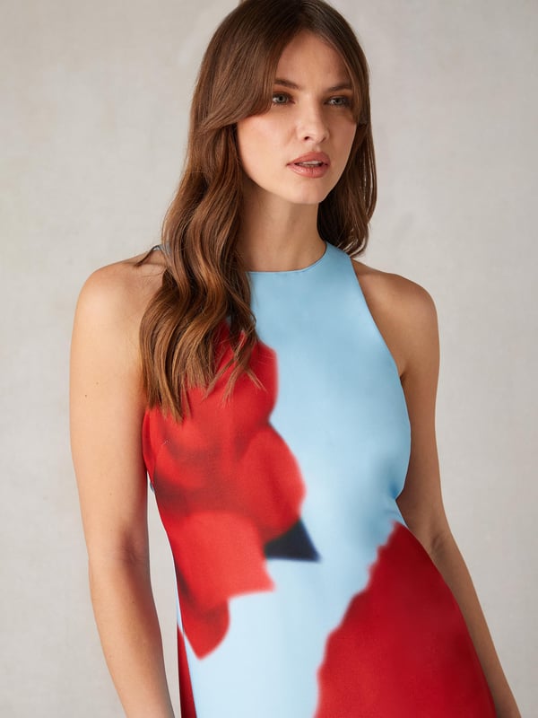 Co-founders' Notes

Introducing our Camilla Red Rose Print Racer Dress, a standout midaxi-length occasionwear piece with a striking large placement red rose print against an icy blue ground colour. Cut from a lightweight crepe, this fabric drapes beautifully in a column silhouette, featuring a stylish racer neckline that adds a contemporary touch to the elegant design. With a convenient zip in the back and fully lined for comfort, this dress seamlessly combines sophistication and style, making it a perfect choice for special occasions.

Midaxi Length

Fully Lined
Back zip
Racer Neckline
True to size. Try your usual size



Fabric &amp; Care



Composition: Main: 51% Recycled Polyester 49% Polyester Lining: 100% Viscose


Garment Care: Machine washable



Size &amp; Fit


True to size. Try your usual size

Length: 135cm (size 10)

Model is 170 cm/5'7" and is wearing a size 10