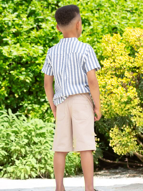 98% organic cotton 2% elastane | Apple enzyme washed for a soft hand feel | Buff | Twill fabric with a little stretch | Side pockets and back welt pockets | Elasticated waistband with adjustable ties | Mock fly detail | Made in Turkey | Machine washable at 40 degrees, or at 30 degrees to be kinder to the planet