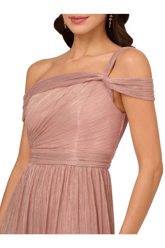 Take the spotlight in this dreamy metallic gown. This formal dress features a shirred bodice with an asymmetrical neckline, draped shoulder sleeves and a single strap at one side, and a side slit cut out of the soft skirt. Crafted from crinkle metallic fabric, this evening gown is fully lined. A zipper closure at the centre back completes the design. Nude heels and a beaded clutch are the perfect accessories to complete this dress for formal and black-tie events.