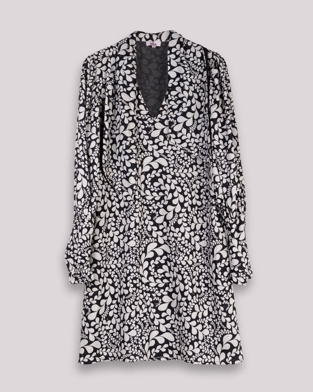 El vestido corto Paula en blanco y negro es sinónimo de elegancia, con este vestido de manga abullonada elevarás tu estilo invernal. Además, su pañuelo a juego te permitirá crear distintos looks con este vestido blanco y negro.
 
 
 
 Vestido corto con cuello pico.
 
 Manga larga acabada con puño con cremallera.
 
 Cierre lateral con cremallera oculta en costura.
 
 Con pañuelo confeccionado en mismo tejido y cara interna con tejido color negro.
 
 Tejido estampado blanco y negro con detalles de foil dorado.