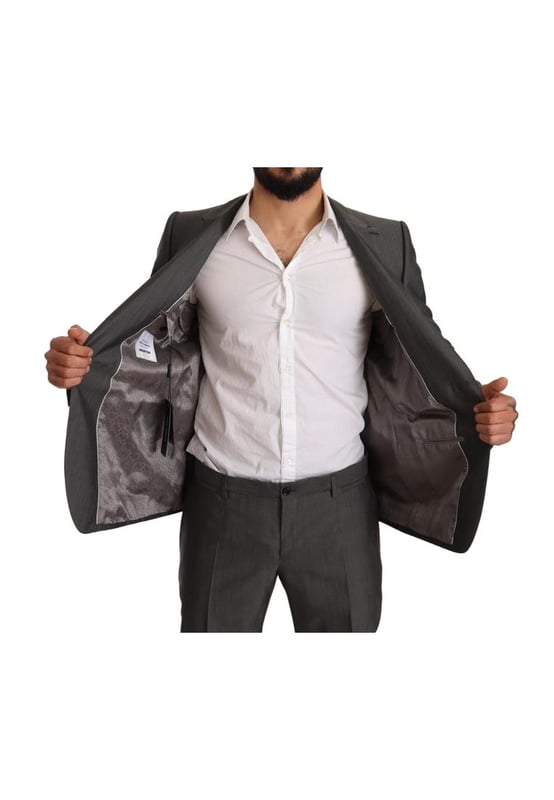 100% Authentic Dolce & Gabbana Suit
  Model: MARTINI
  Style: Single breasted 2 piece suit; includes blazer and pants
  Color: Gray metallic
  Closure: Two button closure
  Fitting: Slim fit
  Two inside pockets
  One open vent in the back
  3-way pants zipper closure
  Logo details
  Made in Italy
  Material: 65% Wool 35% Silk
  Lining: 100% Rayon