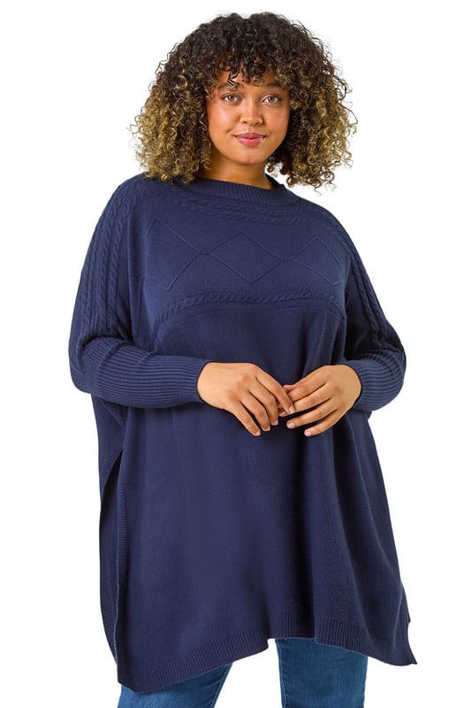 Curve High Neck Cable Knit Poncho from Roman. Wrap up warm in our trendy Curve cable knit poncho, an Autumn Winter must-have to your collection. Featuring a cosy high ribbed neckline, this stylish knit boasts a cable knit yoke detail for added flair. The full length sleeves give a modern touch, while the ribbed hem provides a flattering fit. Pair with jeans and trainers for an effortless stylish look that will keep you warm all season long!