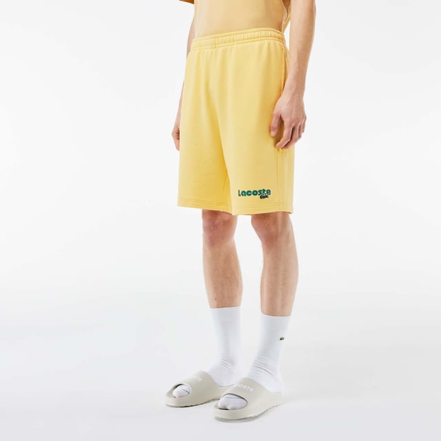 Washed Effect Lacoste Print Jogger Shorts Organic cotton fleece Regular fit  straight cut  Drawstring waist Contrast Lacoste print Embroidered crocodile on front Washed Effect Lacoste Print Jogger Shorts Organic cotton fleece Regular fit  straight cut  Drawstring waist Contrast Lacoste print Embroidered crocodile on front