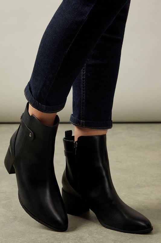 Wide fit design for enhanced comfort
        Elastic gusset for easy slip-on
        Medium block heel measuring between 5 and 6.5cm
        Sleek ankle-length silhouette
        Versatile day-to-night style
    
    Step out in style and comfort with these sophisticated Ahio ankle boots from Wallis. Crafted with a wide fit and featuring an elastic gusset, these boots offer both ease and elegance. The medium block heel, measuring between 5 and 6.5cm, provides a perfect balance of height and stability. Ideal for the woman who values both fashion and function, these boots transition seamlessly from day to night. Pair them with tailored trousers and a crisp blouse for a polished office look, or style them with a flowing midi dress for an evening out. The versatile design makes these boots a wardrobe essential, suitable for various occasions from casual outings to more formal events. With their timeless appeal and practical features, these Wallis boots are set to become your go-to footwear for any season.