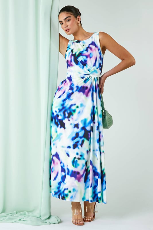 Abstract Print Twist Drape Ruched Maxi Dress from Roman. Take your occasionwear to the next level with this vibrant abstract print maxi dress. Easy to pull on, overhead, this sleeveless style has a flattering twist drape detail at the waist and a timeless round neckline with a stunning v-back. This full length dress exudes evening glamour with its silky, stretch jersey body that skims your figure beautifully. Simply add heels and a statement fascinator for your next Wedding or day at the races!