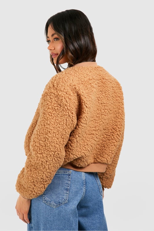 Teddy Faux Fur Bomber Jacket Keep things casual but always on-trend with a piece of outerwear perfection, the bomber jacket. A light jacket featuring a gathered, ribbed waistband and matching cuffs, a bomber jacket is versatile, timeless, and the perfect way to edge up your casual wear. Wear your new women's bomber jacket with a shirt and stripe joggers for the hottest look of the moment: sports luxe, or layer a varsity jacket over a t shirt dress for a fresh new-season look.Style: Faux Fur CoatFabric: BorgSleeve Length: Long Sleeve