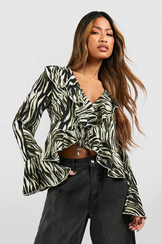 A loose-fitting, lightweight garment with a feminine feel, a blouse is the ultimate wardrobe staple that never goes out of style. Floaty, chic, and far from basic, go from day to night with this classic piece. Whether you choose a floral blouse with jeans for a low-key vibe or drop jaws with a classic satin blouse and trousers, you'll be reaching for this style season after season. Seen in updated prints and classic neutrals, we're talking minimal effort, maximum payoff.Style: BlouseDesign: AnimalFabric: PolyesterLength: RegularNeckline: V NeckSleeve Length: Long SleeveModel's height: 173cm / 5'8"