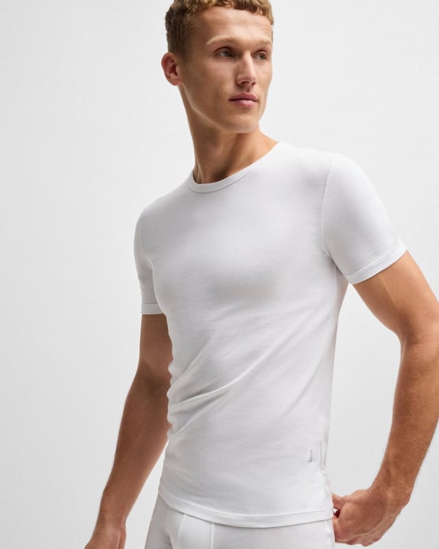 Two short-sleeved underwear T-shirts by BOSS. Crafted in single jersey made from stretch cotton, these super-soft T-shirts are topped with a crew neckline and printed with a subtle BOSS logo at the left-hand side. The slim fit is ideal for layering neatly under an everyday look.

Slim fit
Crew neck
Packaging: Box
Printed Logo

95% Cotton, 5% Elastane 
50475276
 