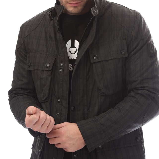 Mens Belstaff Hollingworth Plaid Waxed Cotton Fieldmaster Jacket in charcoal.- Centre front zip fastenings with snap closure placket and buckle-adjusted collar.- Signature tilted left breast pocket.- Four modern  storm proof bellows pockets with dual press stud closure.- Water resistant.- Wind repellent.- Internal drawcord waist channel.- A yarn-dyed cotton plaid with a full water-resistant coating.- Lightly padded tile quilt lining.- Silicone phoenix logo on felt base patch on left sleeve.- High-shine snaps and dark iron hardware.- Shell: 100% Cotton  Body Lining: 100% Cotton- Ref: 105289CHBLK