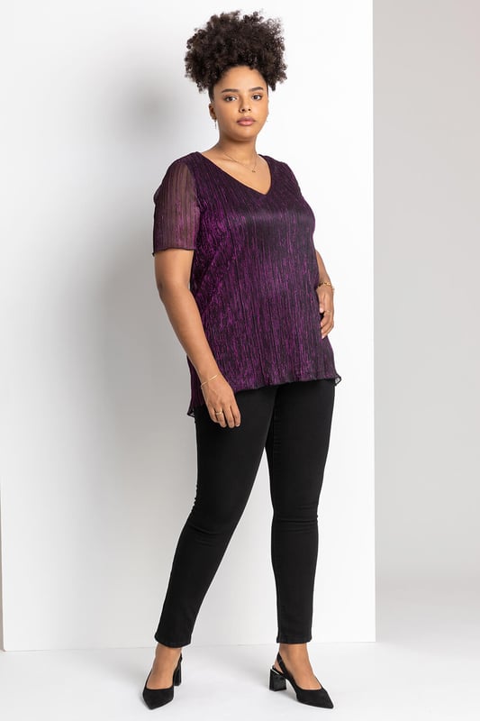 Curve Metallic Plisse Top from Roman. Add effortless glamour to your wardrobe this season with a shimmering ombré number. Cut with a flattering v-neckline and sheer short sleeve, this Curve blouse boasts a delicately pleated bodice and shimmer surface, giving it a beautifully feminine feel. Perfect to throw on over faux leather leggings or dress up in the evening, this ombre top is as versatile as it is striking. Ideal for your Christmas party, pair with the matching plisse cover-up jacket and some wide-leg trousers!